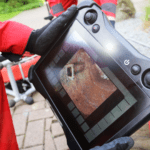High-definition footage displayed during a drain camera inspection showing pipe condition and blockage details.